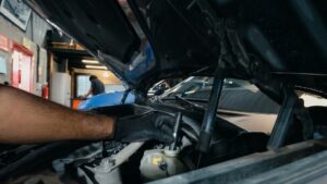 Mechanic checking oil underneath a car